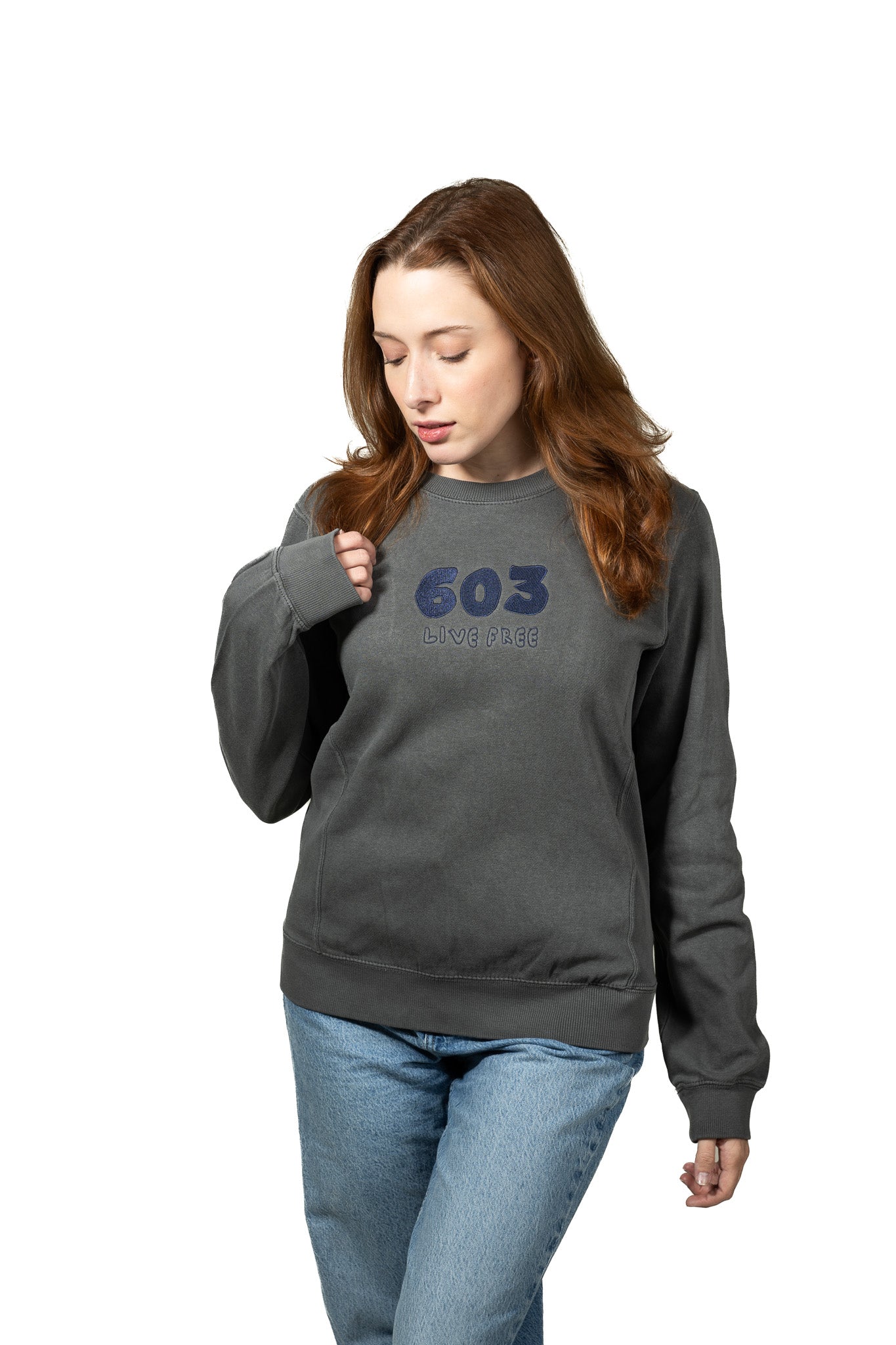 Young woman in dark grey 603 Live Free embroidered crewneck sweatshirt with relaxed fit design