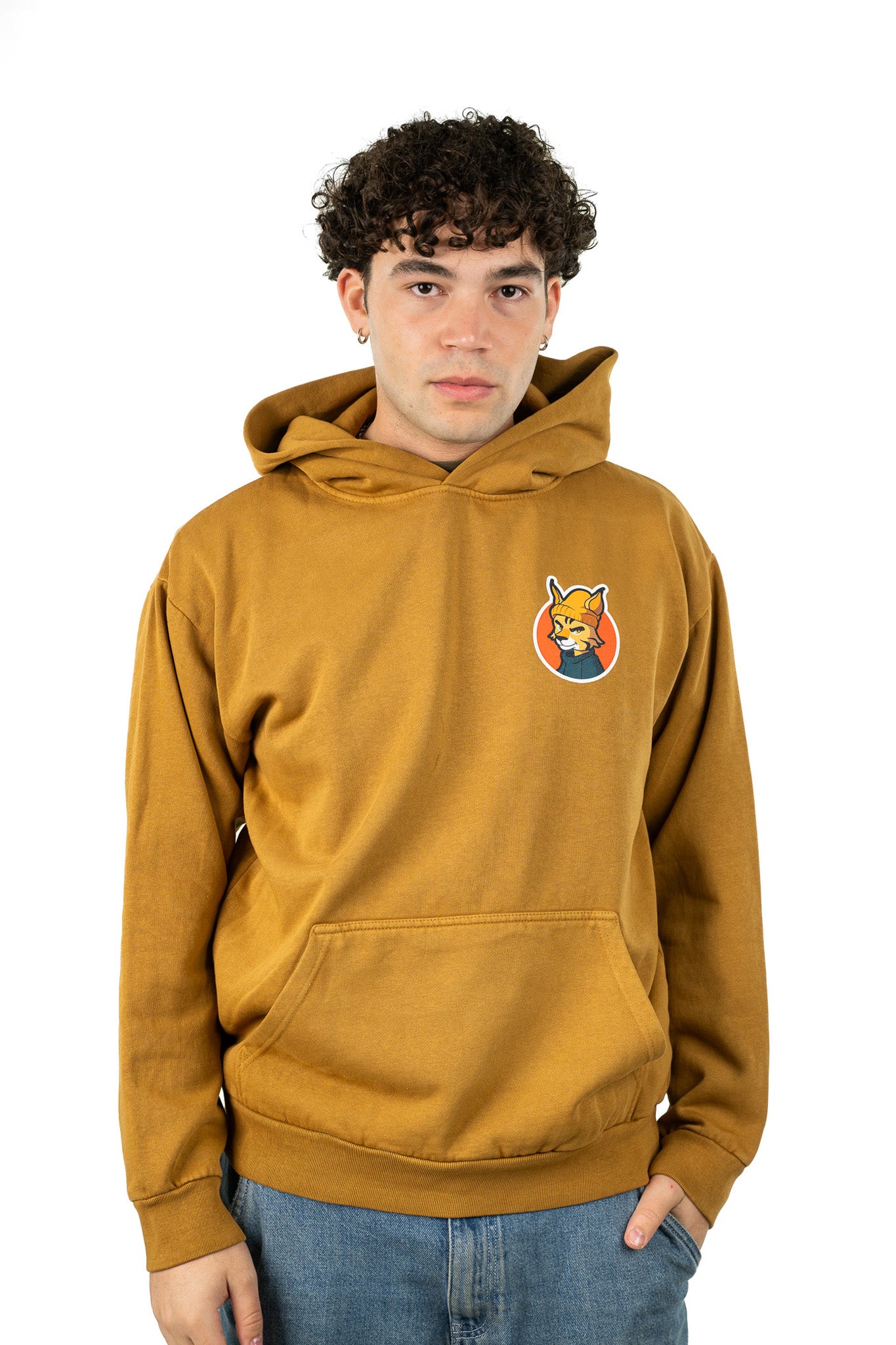 Young man in oversized peanut butter cotton Live Free Hoodie with brand logo graphic on back