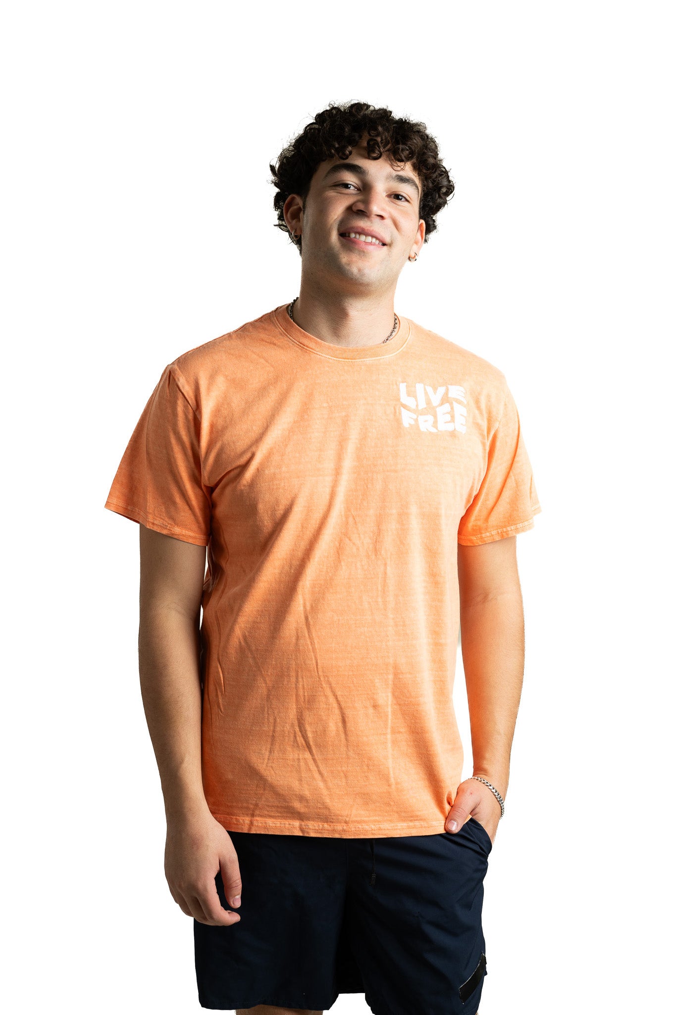 Model wearing light orange Live Free NH embroidered t-shirt with casual, classic fit