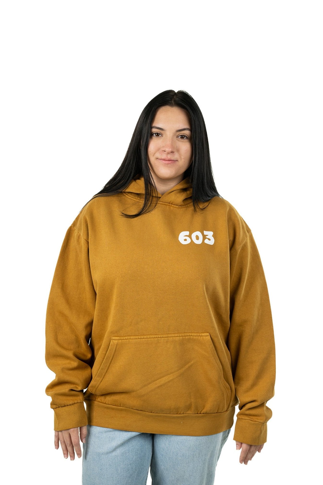 Model in oversized 603 hoodie with Live Free or Die graphic and relaxed streetwear fit