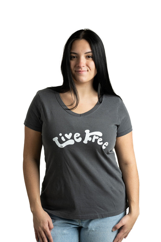 Model in dark gray women's Live Free vintage tee with bold lettering and classic V-neck style